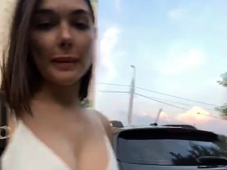 Hot brunette babe outdoors in her lingerie fingering herself