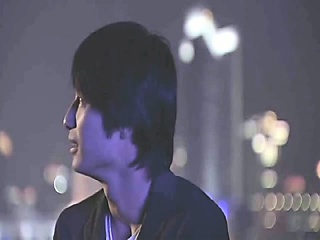 Bai Ling making out with a man as he opens her pink shirt to