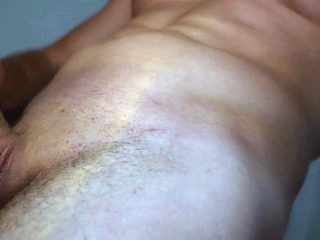 A muscular guy shows his dick in the shower